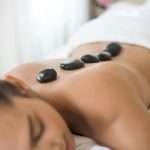 Beautiful woman spa hot stone massage beauty Treatments.