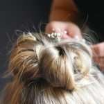 detail of wedding hair style for a flower girl