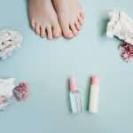 Pink pedicure on a blue background. Top view.